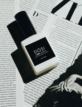 Load image into Gallery viewer, POSI 'I AM LOVED' body spray bottle on a magazine page